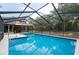 Swim in this sparkling blue pool inside the home's enclosure while enjoying outdoor views at 12311 Oakwood Dr, Hudson, FL 34669