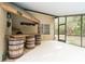 Entertaining porch area with a rustic bar and ample space for guests at 12311 Oakwood Dr, Hudson, FL 34669