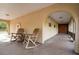 Inviting porch features decorative tile flooring, rocking chairs, and an arched entryway at 12311 Oakwood Dr, Hudson, FL 34669