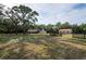 Idyllic horse property featuring a large lot, fenced paddock, and a stucco home with rear-entry garage at 12311 Oakwood Dr, Hudson, FL 34669