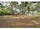 Picturesque estate featuring mature trees and a charming gazebo for outdoor relaxation at 12311 Oakwood Dr, Hudson, FL 34669