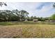 Picturesque property featuring a home and a barn, set amid mature trees and well-maintained lawns at 12311 Oakwood Dr, Hudson, FL 34669