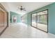 Bright sunroom features sliding glass doors with views of the backyard pool area at 12311 Oakwood Dr, Hudson, FL 34669