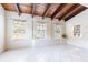 Bright sunroom with three large windows, tiled floors, and a unique stained glass window at 12311 Oakwood Dr, Hudson, FL 34669