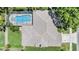 Aerial view showcasing the property's roof, screened-in pool, lush landscaping, and spacious surroundings at 12421 Seabrook Dr, Tampa, FL 33626