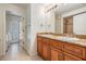 Double sink bathroom with granite countertop and access to laundry room at 12421 Seabrook Dr, Tampa, FL 33626