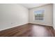 Empty bedroom with a window and dark wood floors at 12421 Seabrook Dr, Tampa, FL 33626