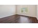 Empty bedroom with wood floors and a window with blinds at 12421 Seabrook Dr, Tampa, FL 33626