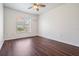 Empty bedroom with dark wood floors and a ceiling fan at 12421 Seabrook Dr, Tampa, FL 33626