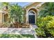 Close-up showcasing a charming front entry with a dark door and decorative landscaping at 12421 Seabrook Dr, Tampa, FL 33626