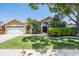 Inviting home featuring a manicured lawn, lush landscaping, and a two-car garage at 12421 Seabrook Dr, Tampa, FL 33626