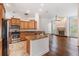 Well-equipped kitchen with stainless steel appliances, granite countertops, and dark hardwood flooring at 12421 Seabrook Dr, Tampa, FL 33626