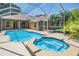 Relax in this screened pool and hot tub area with tropical landscaping, perfect for entertaining and enjoying the Florida sunshine at 12421 Seabrook Dr, Tampa, FL 33626