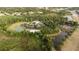 Aerial view displays community pool, tennis courts, ponds, basketball court and lush greenery at 1250 Charlesworth Dr, Wesley Chapel, FL 33543