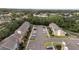 Aerial view of a charming townhome community featuring ample parking and well-kept lawns at 1250 Charlesworth Dr, Wesley Chapel, FL 33543