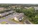 Aerial view of a well-maintained townhome community with ample parking and lush landscaping at 1250 Charlesworth Dr, Wesley Chapel, FL 33543