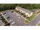 Drone shot of a modern townhome community with ample parking and grassy areas at 1250 Charlesworth Dr, Wesley Chapel, FL 33543