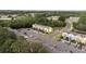 Aerial view of a colorful townhome community featuring ample parking and lush landscaping at 1250 Charlesworth Dr, Wesley Chapel, FL 33543