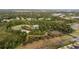 Aerial view showcases community amenities including a pool, basketball court, and tennis courts at 1250 Charlesworth Dr, Wesley Chapel, FL 33543