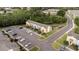 Aerial view showcasing a townhome community with landscaped surroundings and parking at 1250 Charlesworth Dr, Wesley Chapel, FL 33543