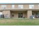 The backyard featuring a patio with outdoor seating and air conditioning units at 1250 Charlesworth Dr, Wesley Chapel, FL 33543
