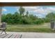 View of backyard with green space from covered patio at 1250 Charlesworth Dr, Wesley Chapel, FL 33543