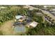 This aerial view showcases the community's pool, clubhouse, playground, tennis court, basketball court, and sand volleyball court at 1250 Charlesworth Dr, Wesley Chapel, FL 33543