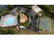This aerial view showcases the community's pool, clubhouse, playground, tennis court, basketball court, and sand volleyball court at 1250 Charlesworth Dr, Wesley Chapel, FL 33543