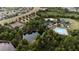 Aerial view of the community with a tennis court, beach volleyball, playground, basketball court, clubhouse and pool at 1250 Charlesworth Dr, Wesley Chapel, FL 33543