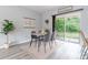 Bright dining area with table set and sliding glass door with natural light at 1250 Charlesworth Dr, Wesley Chapel, FL 33543