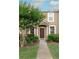 Inviting townhouse entrance with manicured landscaping and a charming covered porch at 1250 Charlesworth Dr, Wesley Chapel, FL 33543