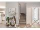 Inviting entryway with staircase, neutral decor, and easy access to the kitchen at 1250 Charlesworth Dr, Wesley Chapel, FL 33543