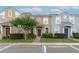 Charming townhomes featuring colorful facades, landscaped grounds, and convenient parking at 1250 Charlesworth Dr, Wesley Chapel, FL 33543