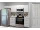 Bright kitchen features stainless steel appliances, white cabinets and countertops at 1250 Charlesworth Dr, Wesley Chapel, FL 33543