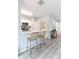 Charming kitchen with a breakfast bar, stainless steel appliances, and convenient access to laundry at 1250 Charlesworth Dr, Wesley Chapel, FL 33543