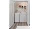 Compact laundry room with washer, dryer and shelving for storage at 1250 Charlesworth Dr, Wesley Chapel, FL 33543