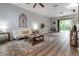 Open-concept living room flows into the dining area, enhanced by wood floors and neutral tones at 1250 Charlesworth Dr, Wesley Chapel, FL 33543