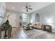 Inviting living room with modern decor, gray wood floors, and a cozy seating area at 1250 Charlesworth Dr, Wesley Chapel, FL 33543