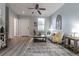 Inviting living room with modern decor, gray wood floors, and a cozy seating area at 1250 Charlesworth Dr, Wesley Chapel, FL 33543