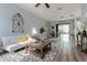 Bright living room with modern furniture, hardwood floors, and sliding glass doors to the outside at 1250 Charlesworth Dr, Wesley Chapel, FL 33543
