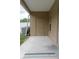 Covered patio with an exterior door, an air conditioner, and a small window at 1250 Charlesworth Dr, Wesley Chapel, FL 33543