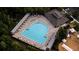 This aerial view showcases the community's pool with lounge seating, tables, and a nearby clubhouse at 1250 Charlesworth Dr, Wesley Chapel, FL 33543