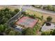 This aerial view highlights the community's tennis courts with a nearby pond and parking at 1250 Charlesworth Dr, Wesley Chapel, FL 33543