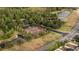 Aerial shot shows the community tennis courts, surrounded by lush landscaping and ponds at 1250 Charlesworth Dr, Wesley Chapel, FL 33543