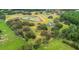 Expansive acreage features ponds and lush trees surrounding a stately home, creating a private, idyllic estate at 13711 Lussier Ln, Spring Hill, FL 34610