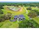 Stunning aerial view of modern estate with a long driveway and lush landscaping at 13711 Lussier Ln, Spring Hill, FL 34610