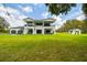 Expansive backyard with a manicured lawn and ample room for outdoor activities at 13711 Lussier Ln, Spring Hill, FL 34610
