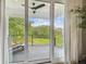 Balcony featuring a lounging chair, a view of the yard and access through sliding glass door at 13711 Lussier Ln, Spring Hill, FL 34610