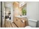 Bright bathroom with a modern vanity, storage, and view into an adjacent bedroom at 13711 Lussier Ln, Spring Hill, FL 34610