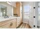 Bright bathroom with quartz counters, wood-look flooring, and a window with natural light at 13711 Lussier Ln, Spring Hill, FL 34610
